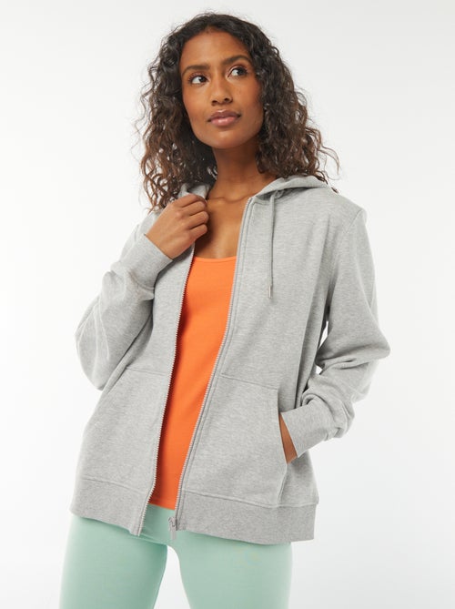 Damesvest van sweatstof met rits en capuchon - Kiabi Damesvest van sweatstof met rits en capuchon - Kiabi