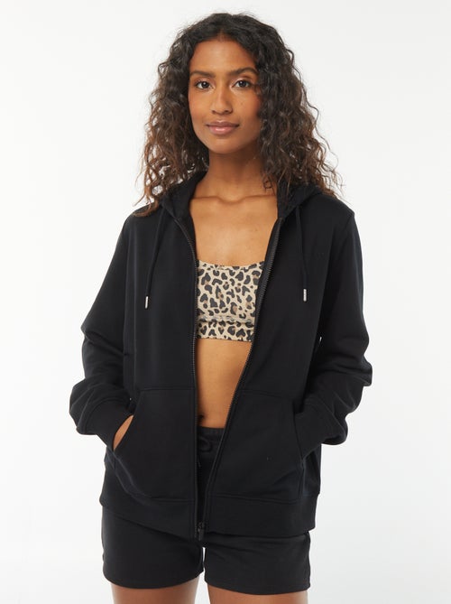 Damesvest van sweatstof met rits en capuchon - Kiabi Damesvest van sweatstof met rits en capuchon - Kiabi