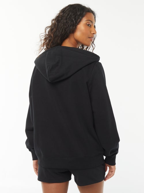 Damesvest van sweatstof met rits en capuchon - Kiabi Damesvest van sweatstof met rits en capuchon - Kiabi