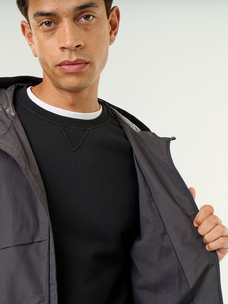 Waterafstotend windjack met capuchon Zwart - Kiabi